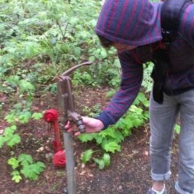 The hike-in sites, although far from the nearest shower, do have both pit toilets and running water nearby.  Here, you see me fiddling with the water pump. 